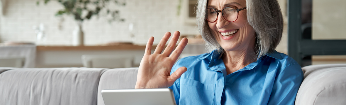 Adult woman smiling while enjoying online Spanish class